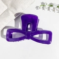 Detail of a large purple UV painted bow hair claw clip with a glossy hollow resin finish - 9.5cm Transparent Blue Purple