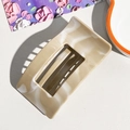 Detail view of square marble pattern hair claw clip on a textured white surface - 9.5cm Square - Khaki (89112)