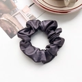 Macro shot of dark purple silk scrunchie showing glossy satin texture and pleats - Silk Pleated Large Scrunchie - Dark Purple