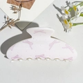 Close-up of semi-round hair claw with pink bow pattern and smooth acrylic texture - UV Printed Square Head-Cream White 167-4