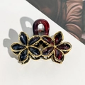 Close-up of gold-plated flower hair claw with deep red and blue glossy enamel petals - 9cm Gold Edge Double Flower - Black Red