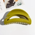 Close-up of olive green glossy claw clip showing hollow semi-circular design and teeth - Mustard Yellow Moon Style