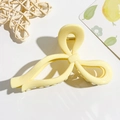 Detailed top view of a cream yellow moon-shaped claw clip with a strong gold spring - Cream Yellow Bow Style