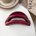 Close-up of a burgundy square hair claw clip on a minimalist lifestyle magazine background - Moon Clip / Silicone / Glossy Wine Red