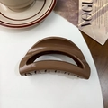 Close-up of brown semi-circular shark hair claw clip on a stylish VOGUE magazine - Moon Clip / Silicone / Glossy Coffee