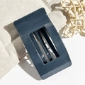 Close-up of a 9.5cm dark grey-blue rectangle hair claw clip with a hollow grid design - Navy Blue