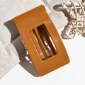 Detail of 9.5cm rectangular hair claw clip in deep caramel color with cutout design - Orange