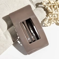 Detailed view of a brown rectangular hair claw clip with cutout design on linen fabric - Brown
