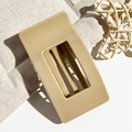 Close-up of a 9.5cm large khaki rectangular hair claw clip on textured beige fabric - Milk Coffee