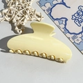 Detail view of cream semicircular hair claw clip on decorative cloud bear background - 10.5CM Square Head / Milky Yellow