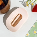 Detailed view of a light pink matte hollow hair claw clip on a minimalist wooden background - Circular Clip / Light Pink