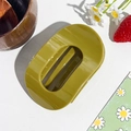 Detail of avocado green oval hair claw clip with glossy finish and minimalist hollow design - Oval Clip / Mustard Yellow