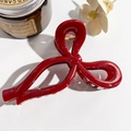 Detailed view of a large glossy red bow hair claw clip with a durable gold metal spring - Solid Wine Red