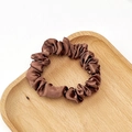 Detail of soft brown satin scrunchie showing pleated silk texture on a wooden tray - Dark Coffee
