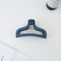Macro detail of the dark blue matte hair claw clip with its non-slip hollow structure - Blue Gray