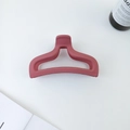 Close-up of matte dark pink hair claw clip with geometric hollow fishtail design - Dusty Pink