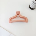Close-up of a matte coral pink mermaid tail hair claw clip on a white background - Ivory