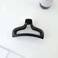 Detail of matte black hollow mermaid tail hair claw clip on clean white background - Black