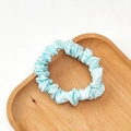 Light blue satin scrunchie with a glossy silk finish on a minimalist wooden tray - Sky Blue