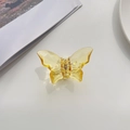 Detail view of yellow translucent butterfly hair claw with golden metal spring - Yellow
