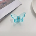 Detailed view of large transparent blue butterfly hair claw clip with bionic wings on white surface - Blue 1