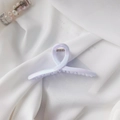 Detailed macro view of the iridescent purple hair claw clip with metallic spring on fabric - Iridescent Cross Style (4846925253250)
