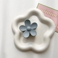Detail of light blue matte flower hair claw clip displayed on a white ceramic plate - Gray