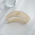 Detail of translucent cream shark hair clip with gold spring on white surface - Moon Style Light Orange