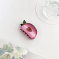 Detail of pink acrylic apple hair claw clip with leaf accent on a minimalist background - Peach