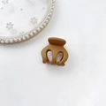 Detail shot showing the matte coffee brown mini hair claw clip for high ponytail styling - Plastic/Resin / Pumpkin Clip-Ginger