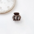 Close-up of matte brown mini hair claw clip for ponytail on a white floral background - Plastic/Resin / Pumpkin Clip-Coffee