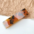 Detail of a rectangular tortoiseshell hair clip on a minimalist textured paper background - Leopard Dark Coffee