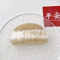 Close-up of beige marble pattern acrylic hair claw clip on decorative glass plate - Champagne Water Ripple Round Head