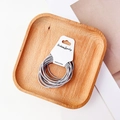 Detail of high-elasticity grey woven hair ties neatly wrapped on a white display card - Gray