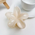 Detail view of cream white frangipani hair claw clip with pearl texture and strong grip teeth - Jelly Beige