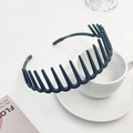 Detailed close-up of dark grey matte headband with teeth on white coffee cup - Blue Gray