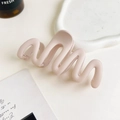 Detailed view of pink wavy matte hair claw clip on a stylish decorative tray - 11cm Wave / Matte Korean Pink