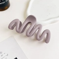 Close-up of a matte purple wavy hair claw clip on a minimalist white ceramic tray - 11cm Wave / Matte Purple Gray