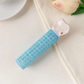 Detail of blue self-grip hair roller with pink heart-shaped clip on soft fabric - Plastic / Blue