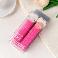 Close-up of pink hair root clips in clear packaging with elegant floral background - Plastic / Rose Red