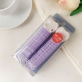 Close-up of two purple self-adhesive hair rollers for volume with styling clips - Plastic / Lavender Purple