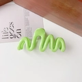 Detail of light green wavy claw clip on white surface with modern minimalist design - 11cm Wave / Glossy Fruit Green