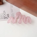 Detail view of a pink wavy resin hair claw clip on a minimalist white background - 11cm Wave / Jelly Pink