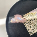 Detail of pink iridescent resin hair claw clip with shell texture on black tray - 8cm Square Head Claw Clip / Phantom Pink