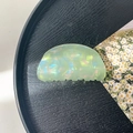 Macro detail of the light green iridescent crescent hair claw clip on a black tray - 8cm Round Head Claw Clip / Iridescent Green
