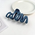 Macro detail of dark blue matte wave hair claw clip on elegant white ceramic plate - Plastic/Resin / Royal Blue