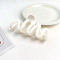 Detailed view of large wave hair claw clip with matte cream finish and curved design - Plastic/Resin / Cream