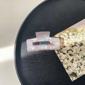 Detail of square acetate hair claw clip with iridescent pearlescent finish on a tray - 7.5cm Rectangle Claw Clip / Phantom Purple