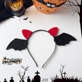 Detail view of Halloween headband with red devil horns and black felt bat wings for party - Large Horn Black Wings Style