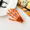 Dettaglio molletta per capelli a mano di scheletro arancione brillante per Halloween - Arancione